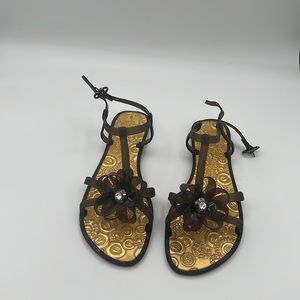 Olive sturdy plastic pool sandal with flower design and stone detail gold floor